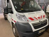 a white van with red stripes parked in a garage