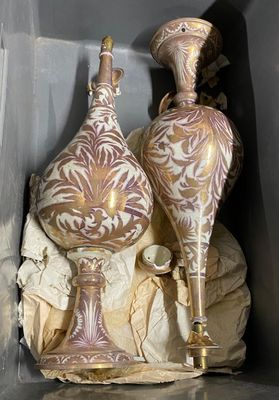 two vases that are sitting on a rock