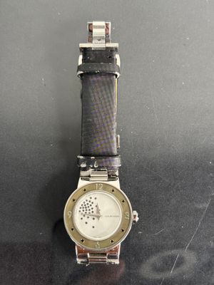an image of a watch on a table with a black background