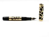 an image of a pen with a black and gold design on it
