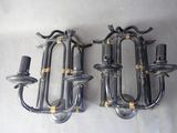 two wall sconces that are attached to the wall