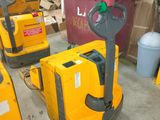 several yellow forklifts are lined up in a warehouse