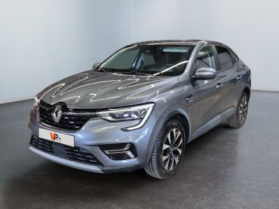 a grey car parked in a room with a white wall
