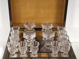a wooden box that has a set of glasses in it