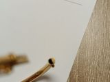 a pen and a piece of paper sitting on a table