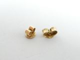 a pair of gold plated earrings on a white surface