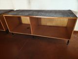 a wooden shelf with a concrete top in a room