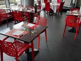 tables and chairs in a restaurant with a view of the city