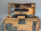an old wooden box with a bunch of wires in it