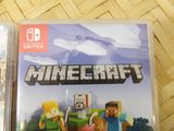 nintendo switch console game with a minecraft video game on top of it
