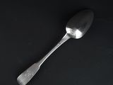 a spoon that is sitting on a black surface