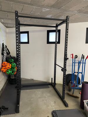 an image of a gym room with a barbell rack and other equipment