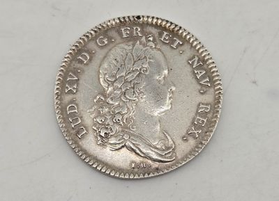 a close up of a coin on a white surface