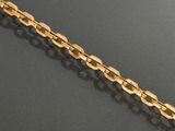 an image of a gold chain on a black surface