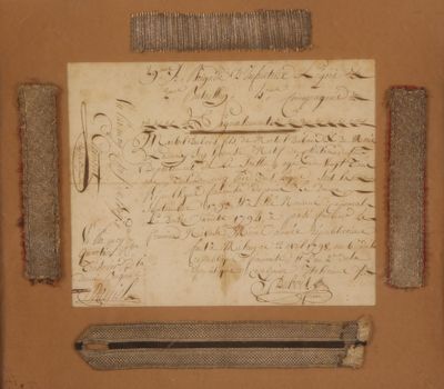 un bout de papier sur lequel il y a quelque chose d'écrit, à côté d'une paire de ciseaux et d'une paire de ciseaux
