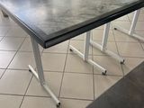 two tables that are sitting on a tiled floor