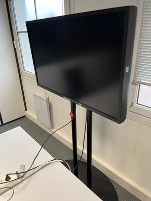 a flat screen tv sitting on a stand in a room