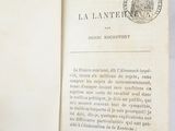 an open book with a stamp on it sitting on top of a table