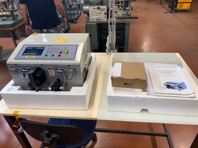two machines that are sitting on a table in a factory