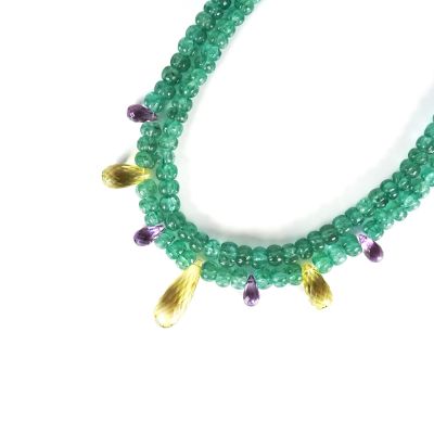 green and purple beaded necklace with gold accents on a white background