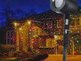 a close up of a light that is on a pole in front of a house