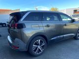 the rear end of a grey suv parked in a parking lot