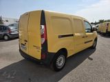 yellow van parked in a parking lot with other cars in the background