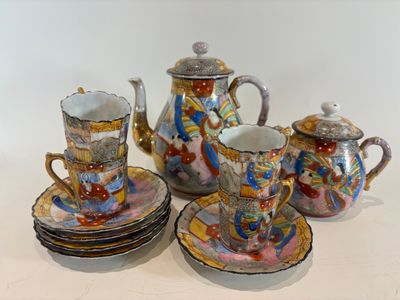 a group of tea and coffee cups and saucers on a table