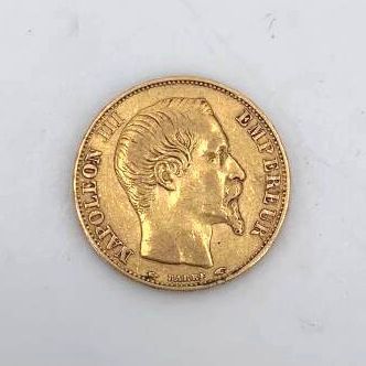 a close up of a gold coin on a white surface