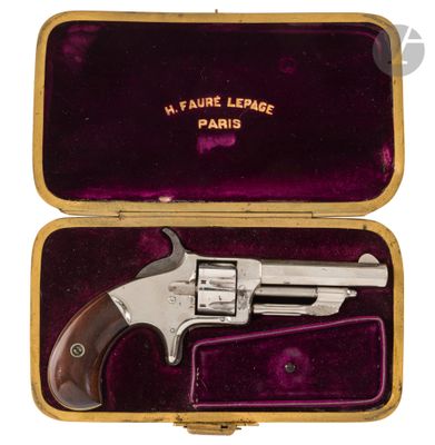 a silver revolver in a purple case on a white background