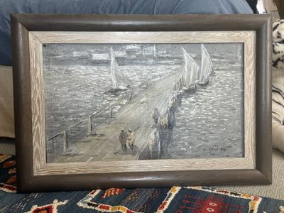 a picture of a painting on the floor next to a bed