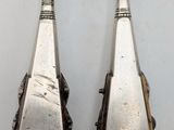 pair of antique silverware spoons on a white surface