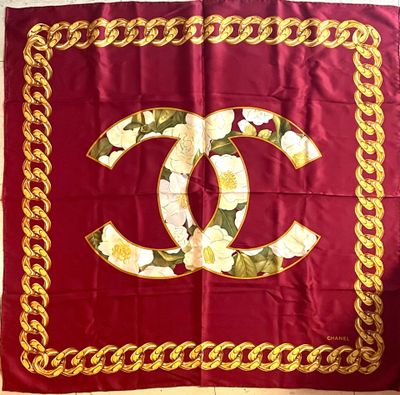 red and gold chanel scarf with white flowers and gold chains