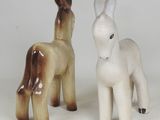 two figurines of donkeys standing next to each other