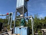 un conteneur bleu posé au sommet d'un tas de bois