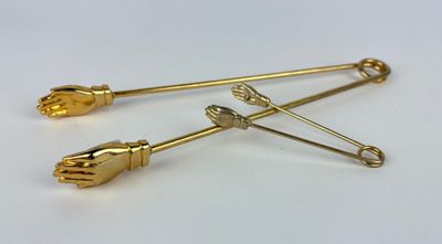 pair of gold plated hand and foot brooches