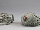 pair of silver and brown ceramic fish sculptures on a gray surface