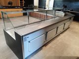 a counter with a glass display case in the middle of it