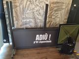 a sign that says adju on it in front of a wall