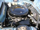 a blue car engine with the hood up and the hood down
