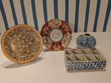 three plates and a bowl sitting on a table