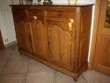an image of a wooden cabinet with a vase on top of it