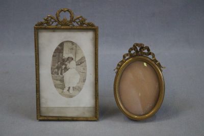 an old picture frame with a picture of a little girl in a white dress and a picture of a little girl in a white dress