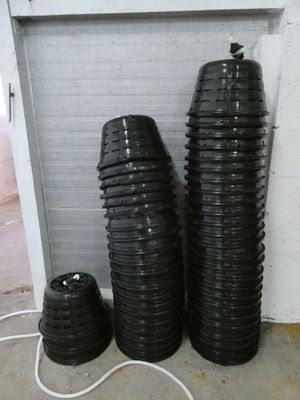 three stacks of black plastic cups sitting next to each other