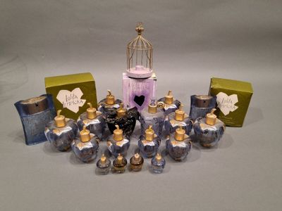 many small bottles of perfume sitting on a table