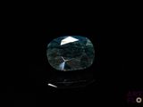 a close up of a blue diamond on a black surface