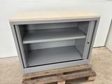 a grey metal cabinet with a wooden top and shelves on pallets