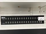 an image of a black and white shelf with a bunch of wires on it