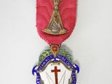 a medal with a cross on it and a ribbon around it