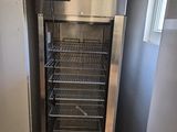 an image of a kitchen with a refrigerator and a freezer